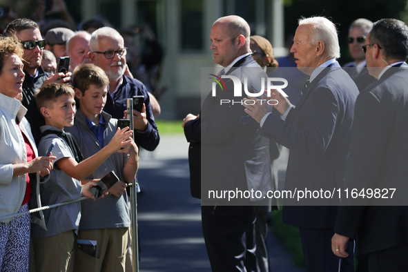 U.S. President Joe Biden speaks with guests at the White House before boarding Marine One en route to Milwaukee, Wisconsin and Philadelphia,...