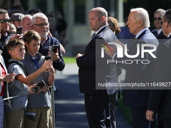 U.S. President Joe Biden speaks with guests at the White House before boarding Marine One en route to Milwaukee, Wisconsin and Philadelphia,...