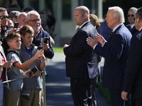 U.S. President Joe Biden speaks with guests at the White House before boarding Marine One en route to Milwaukee, Wisconsin and Philadelphia,...