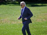 U.S. President Joe Biden jogs to speak with guests before boarding Marine One en route to Milwaukee, Wisconsin and Philadelphia, Pennsylvani...