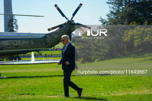 US President Joe Biden walks on the South Lawn of the White House before boarding Marine One in Washington, DC, US, on Tuesday, Oct. 8, 2024...