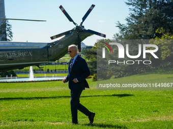 US President Joe Biden walks on the South Lawn of the White House before boarding Marine One in Washington, DC, US, on Tuesday, Oct. 8, 2024...