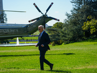 US President Joe Biden walks on the South Lawn of the White House before boarding Marine One in Washington, DC, US, on Tuesday, Oct. 8, 2024...