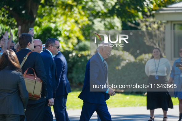 US President Joe Biden walks on the South Lawn of the White House before boarding Marine One in Washington, DC, US, on Tuesday, Oct. 8, 2024...