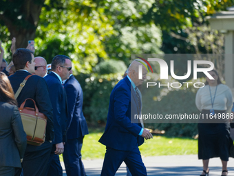 US President Joe Biden walks on the South Lawn of the White House before boarding Marine One in Washington, DC, US, on Tuesday, Oct. 8, 2024...