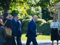 US President Joe Biden walks on the South Lawn of the White House before boarding Marine One in Washington, DC, US, on Tuesday, Oct. 8, 2024...