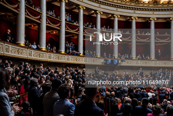 At the National Assembly in Paris, France, on October 8, 2024, applause and deputies stand in honor of the families of two Franco-Israeli ho...