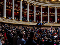 At the National Assembly in Paris, France, on October 8, 2024, applause and deputies stand in honor of the families of two Franco-Israeli ho...