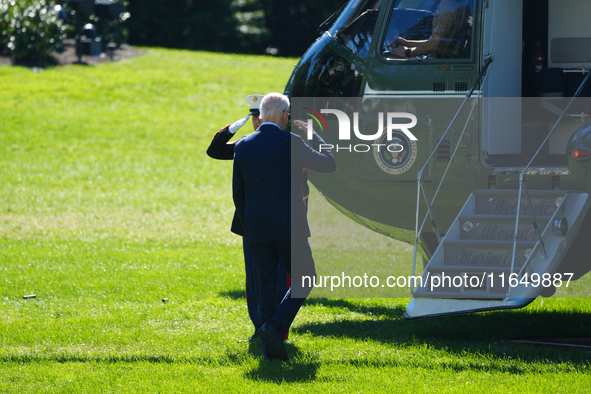 US President Joe Biden walks on the South Lawn of the White House before boarding Marine One in Washington, DC, US, on Tuesday, Oct. 8, 2024...