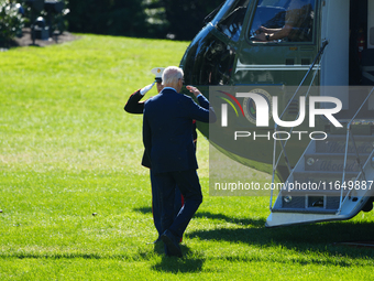 US President Joe Biden walks on the South Lawn of the White House before boarding Marine One in Washington, DC, US, on Tuesday, Oct. 8, 2024...