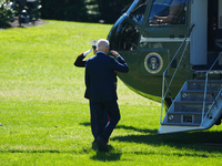 US President Joe Biden walks on the South Lawn of the White House before boarding Marine One in Washington, DC, US, on Tuesday, Oct. 8, 2024...