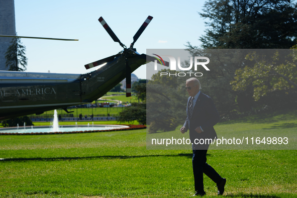 US President Joe Biden walks on the South Lawn of the White House before boarding Marine One in Washington, DC, US, on Tuesday, Oct. 8, 2024...