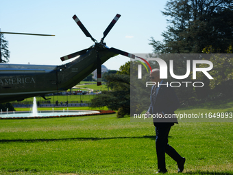 US President Joe Biden walks on the South Lawn of the White House before boarding Marine One in Washington, DC, US, on Tuesday, Oct. 8, 2024...