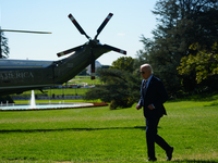 US President Joe Biden walks on the South Lawn of the White House before boarding Marine One in Washington, DC, US, on Tuesday, Oct. 8, 2024...