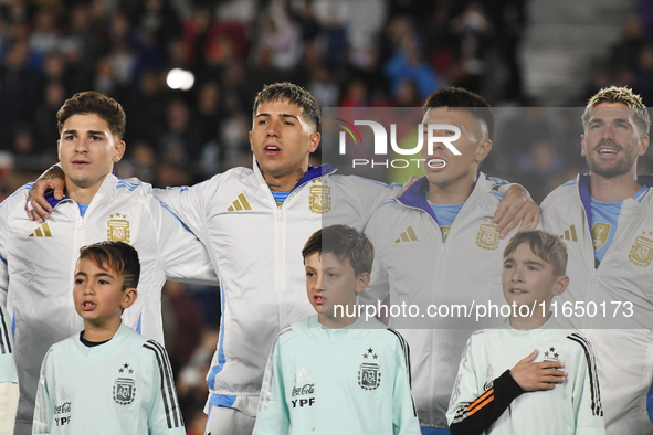 Julian Alvarez, Enzo Fernandez, Lisandro Martinez, and Rodrigo De Paul of Argentina stand during the national anthems ceremony before a matc...