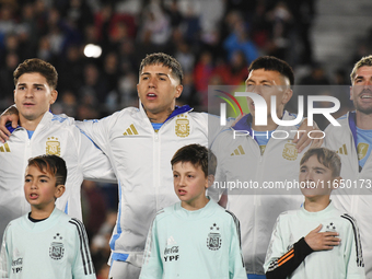 Julian Alvarez, Enzo Fernandez, Lisandro Martinez, and Rodrigo De Paul of Argentina stand during the national anthems ceremony before a matc...