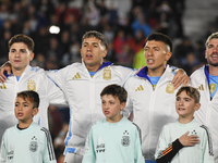 Julian Alvarez, Enzo Fernandez, Lisandro Martinez, and Rodrigo De Paul of Argentina stand during the national anthems ceremony before a matc...