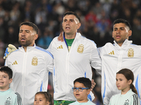 Nicolas Otamendi, Emiliano Martinez, and Cristian Romero stand during the national anthems ceremony before a match between Argentina and Chi...