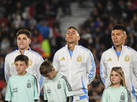 Julian Alvarez, Enzo Fernandez, and Lisandro Martinez of Argentina stand during the national anthems ceremony before a match between Argenti...