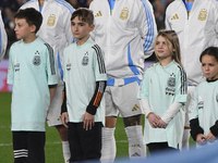 Julian Alvarez, Enzo Fernandez, and Lisandro Martinez of Argentina stand during the national anthems ceremony before a match between Argenti...