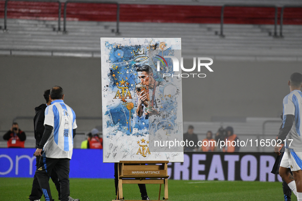 Angel Di Maria celebrates his retirement with his former teammates before a match between Argentina and Chile at Estadio Mas Monumental Anto...