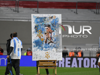 Angel Di Maria celebrates his retirement with his former teammates before a match between Argentina and Chile at Estadio Mas Monumental Anto...