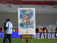 Angel Di Maria celebrates his retirement with his former teammates before a match between Argentina and Chile at Estadio Mas Monumental Anto...