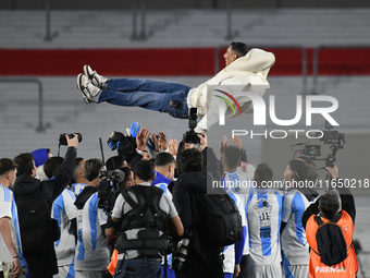 Angel Di Maria celebrates his retirement with his former teammates before a match between Argentina and Chile at Estadio Mas Monumental Anto...