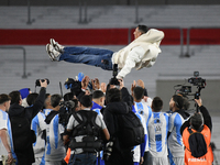 Angel Di Maria celebrates his retirement with his former teammates before a match between Argentina and Chile at Estadio Mas Monumental Anto...