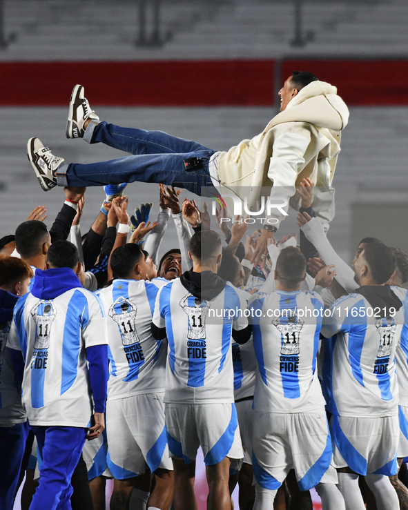 Angel Di Maria celebrates his retirement with his former teammates before a match between Argentina and Chile at Estadio Mas Monumental Anto...