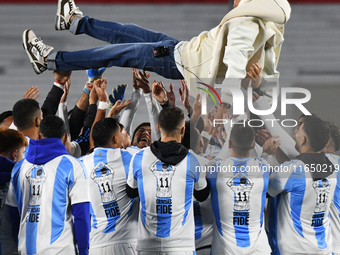 Angel Di Maria celebrates his retirement with his former teammates before a match between Argentina and Chile at Estadio Mas Monumental Anto...