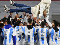 Angel Di Maria celebrates his retirement with his former teammates before a match between Argentina and Chile at Estadio Mas Monumental Anto...