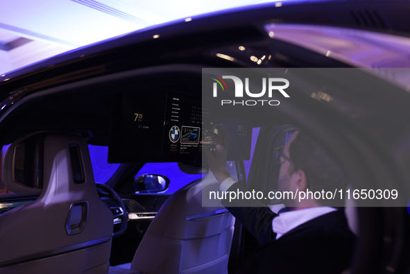 A man controls a touch screen panel of a BMW i7 electric car during a press conference of a joint venture between Tata Technologies and BMW...