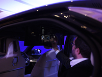 A man controls a touch screen panel of a BMW i7 electric car during a press conference of a joint venture between Tata Technologies and BMW...