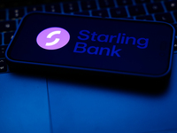 A laptop keyboard and Starling Bank logo displayed on a phone screen are seen in this illustration photo taken in Poland on October 8, 2024....