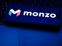 A laptop keyboard and Monzo logo displayed on a phone screen are seen in this illustration photo taken in Poland on October 8, 2024. (