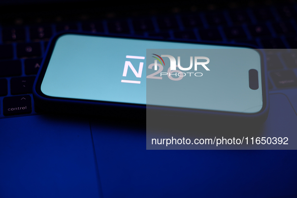 A laptop keyboard and N26 logo displayed on a phone screen are seen in this illustration photo taken in Poland on October 8, 2024. 