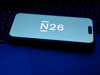 A laptop keyboard and N26 logo displayed on a phone screen are seen in this illustration photo taken in Poland on October 8, 2024. (