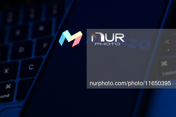 A laptop keyboard and Monzo logo displayed on a phone screen are seen in this illustration photo taken in Poland on October 8, 2024. 