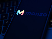 A laptop keyboard and Monzo logo displayed on a phone screen are seen in this illustration photo taken in Poland on October 8, 2024. (