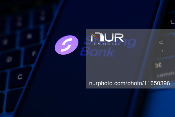 A laptop keyboard and Starling Bank logo displayed on a phone screen are seen in this illustration photo taken in Poland on October 8, 2024....