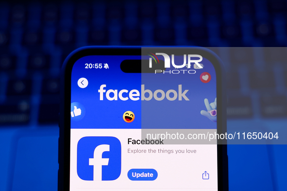 A laptop keyboard and Facebook on App Store displayed on a phone screen are seen in this illustration photo taken in Poland on October 8, 20...