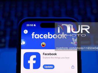 A laptop keyboard and Facebook on App Store displayed on a phone screen are seen in this illustration photo taken in Poland on October 8, 20...