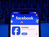 A laptop keyboard and Facebook on App Store displayed on a phone screen are seen in this illustration photo taken in Poland on October 8, 20...