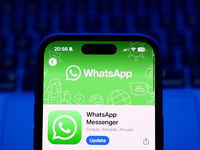 A laptop keyboard and WhatsApp on App Store displayed on a phone screen are seen in this illustration photo taken in Poland on October 8, 20...