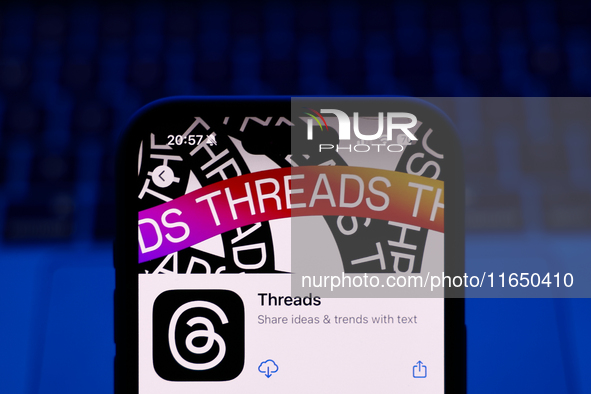 A laptop keyboard and Threads on App Store displayed on a phone screen are seen in this illustration photo taken in Poland on October 8, 202...