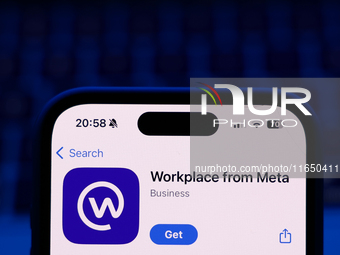 A laptop keyboard and Workplace on App Store displayed on a phone screen are seen in this illustration photo taken in Poland on October 8, 2...