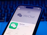 A laptop keyboard and WeChat on App Store displayed on a phone screen are seen in this illustration photo taken in Poland on October 8, 2024...