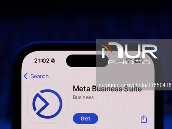 A laptop keyboard and Meta Business Suite on App Store displayed on a phone screen are seen in this illustration photo taken in Poland on Oc...