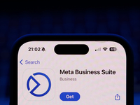 A laptop keyboard and Meta Business Suite on App Store displayed on a phone screen are seen in this illustration photo taken in Poland on Oc...